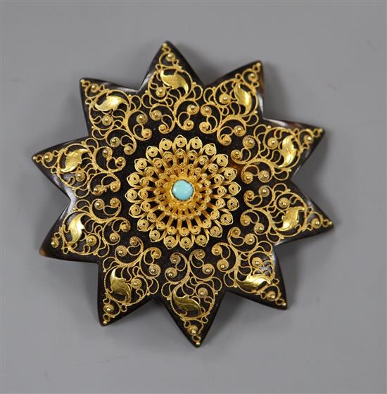 A late Victorian yellow metal mounted tortoiseshell sat brooch, with cannetile work decoration and central turquoise, 46mm.